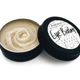 Eye balm in black tin with beige cream and KaromniCo label