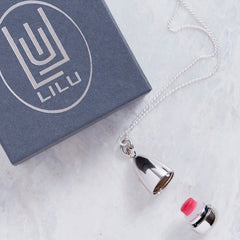 Necklace with silver chain and pendant, LILU logo on gray box, and red and white object
