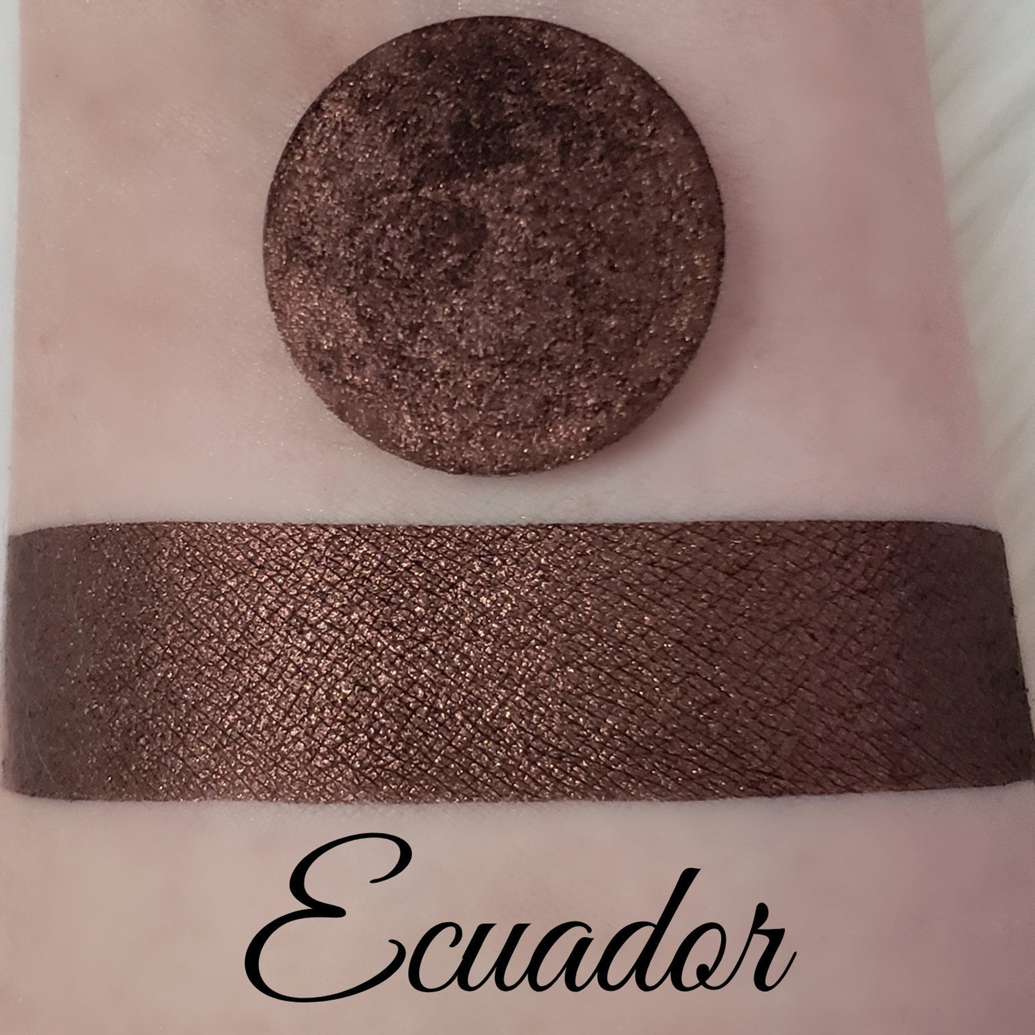 Shimmer eyeshadow swatch, dark brown, textured, with "Ecuador" text