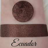 Shimmer eyeshadow swatch, dark brown, textured, with "Ecuador" text