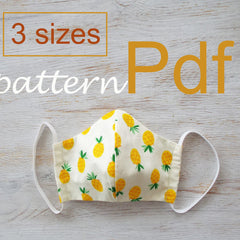 Close-up of washable cotton face mask pattern showing multi-layer fabric texture and adjustable ear loops