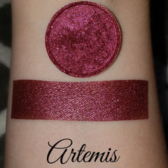 Eyeshadow swatch with shimmer, burgundy color, and Artemis brand name