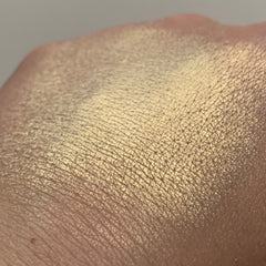 Gold shimmer on skin, showing texture and light reflection