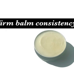 Balm in silver tin, pale yellow color, firm consistency, on white background