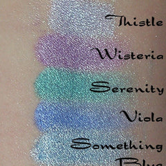 Side view of wisteria pastel purple eyeshadow pan showing smooth matte texture and compact size