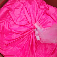 Pink plastic bag with tied closure, shiny material, and crinkled texture