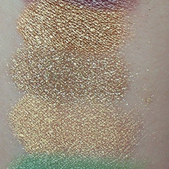 Hand applying sage green matte eyeshadow to eyelid with fingertip for soft blend