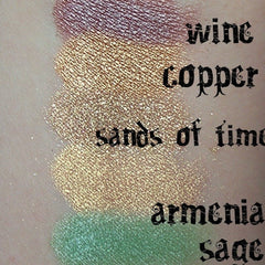 Side view of sage green matte eyeshadow pan showing smooth powder texture and compact size