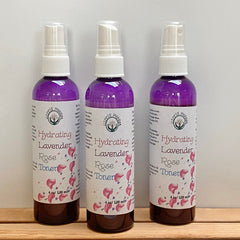 Rose Toner bottles with purple liquid, white labels, and clear spray tops, Hippie Pharm brand