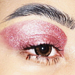 Close-up of vegan mauve eyeshadow pigment with soft matte texture in compact pan