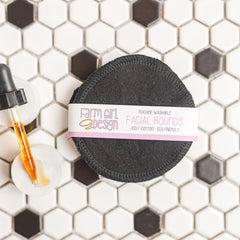 Facial rounds, black cotton pads with stitched edge, Farm Girl Design label visible