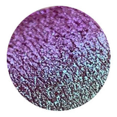 Purple and teal eyeshadow swatch with shimmery finish in a circular shape