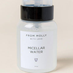 Micellar water bottle with black cap, clear plastic, and white label with text FROM MOLLY WITH LOVE