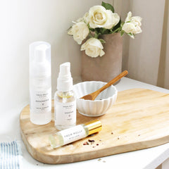 Skincare products on wooden board with white bottles and flowers, "From Molly With Love" branding visible