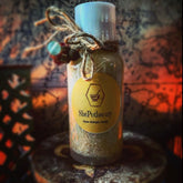 Skin care product bottle with white cap, brown twine, and ShePothecary label