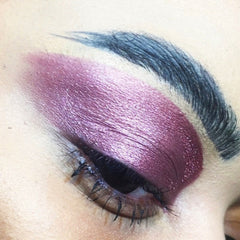 Side view of mauve vegan eyeshadow pigment in compact with mirrored lid and embossed logo