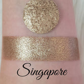 Shimmer eyeshadow swatch, gold color, textured appearance, with name "Singapore
