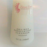 Exfoliating cleanser bottle, off-white with pink logo, text "Forever Young" visible
