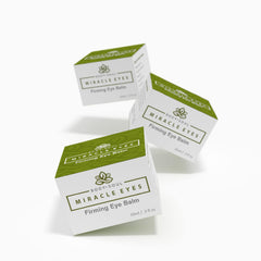 Firming Eye Balm product boxes with white, green, and black text, floating in a group