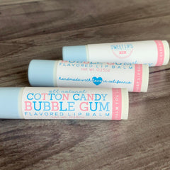 Lip balm tubes with blue and white packaging, pink and blue text, and Sweet Lips branding.