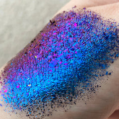 Side view of Tala Foil Thunderstorm Eye Shadow Pigment in metallic silver-blue shade with reflective foil finish