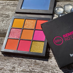 Eyeshadow palette with multiple bright colors and RRO branding on black case