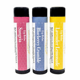 Lip balm tubes in pink, blue, and yellow with honeycomb pattern, Sister Bees brand visible
