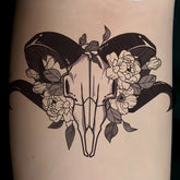 Body makeup temporary tattoo with floral deer skull design, black and gray, feminine style
