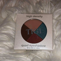 Side view of TIGI Eye Shadow Palette displaying matte and shimmer shades in neutral tones with sleek black compact