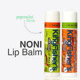 Noni lip balm tubes with white caps, green and orange labels, Kingfisher's brand name visible