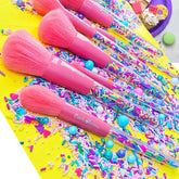 Set of three pastel-colored eyeshadow brushes with pink, blue, and purple handles and soft synthetic bristles