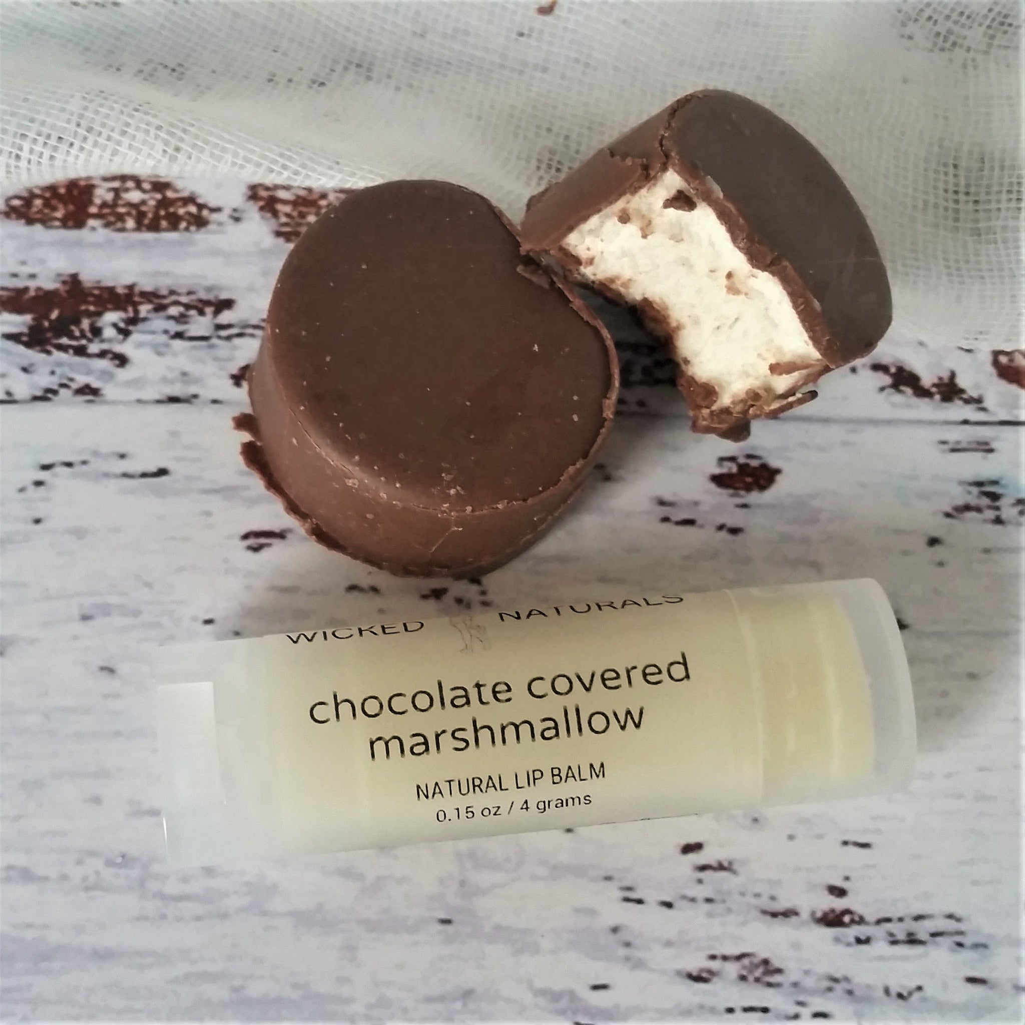 Lip balm with chocolate covered marshmallow, brown chocolate, white marshmallow, and Wicked Naturals label