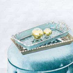 Tray set with ornate silver and blue frames holding cosmetic jars, OULMAS text visible