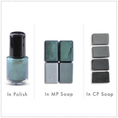 Nail polish bottle with black cap, green-blue liquid, and soap bars in various shades of gray