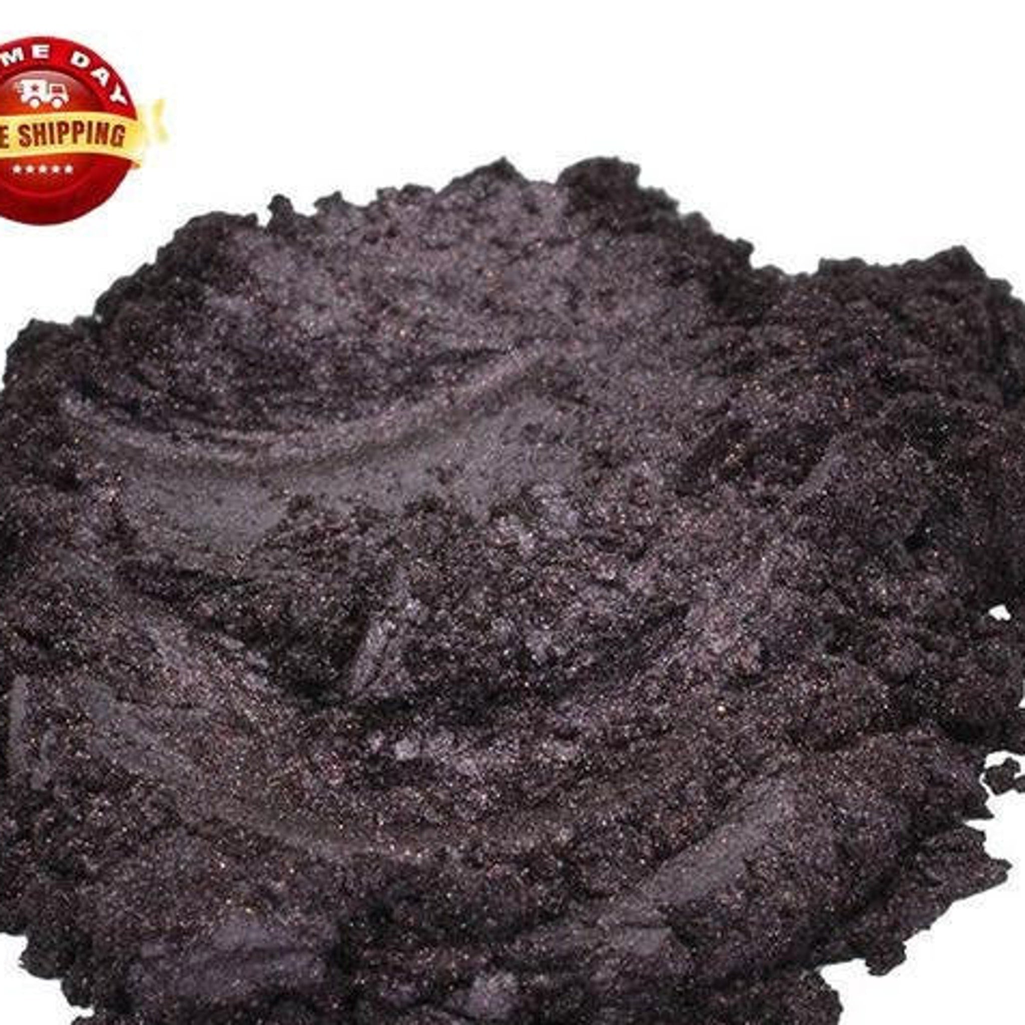 Cosmetic pigment powder, dark plum color, mica texture, BLACKSTAR brand visible