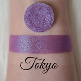 Shimmer eyeshadow, purple pressed pigment, swatch on skin, "Tokyo" text visible