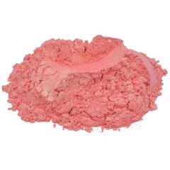 Pink powder with shimmer and granular texture, possibly cosmetic use