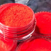 Vibrant red ultra-pigmented eyeshadow in a compact with mirrored lid and gold branding.