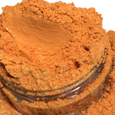 Shimmer eyeshadow, bright orange powder with glitter, in a clear jar