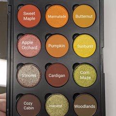 Side view of Autumn Splendor eyeshadow palette showcasing warm yellow, orange, and red matte shades with green and brown accents