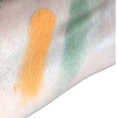 Eyeshadow swatches, orange and green powder, applied on skin for color test