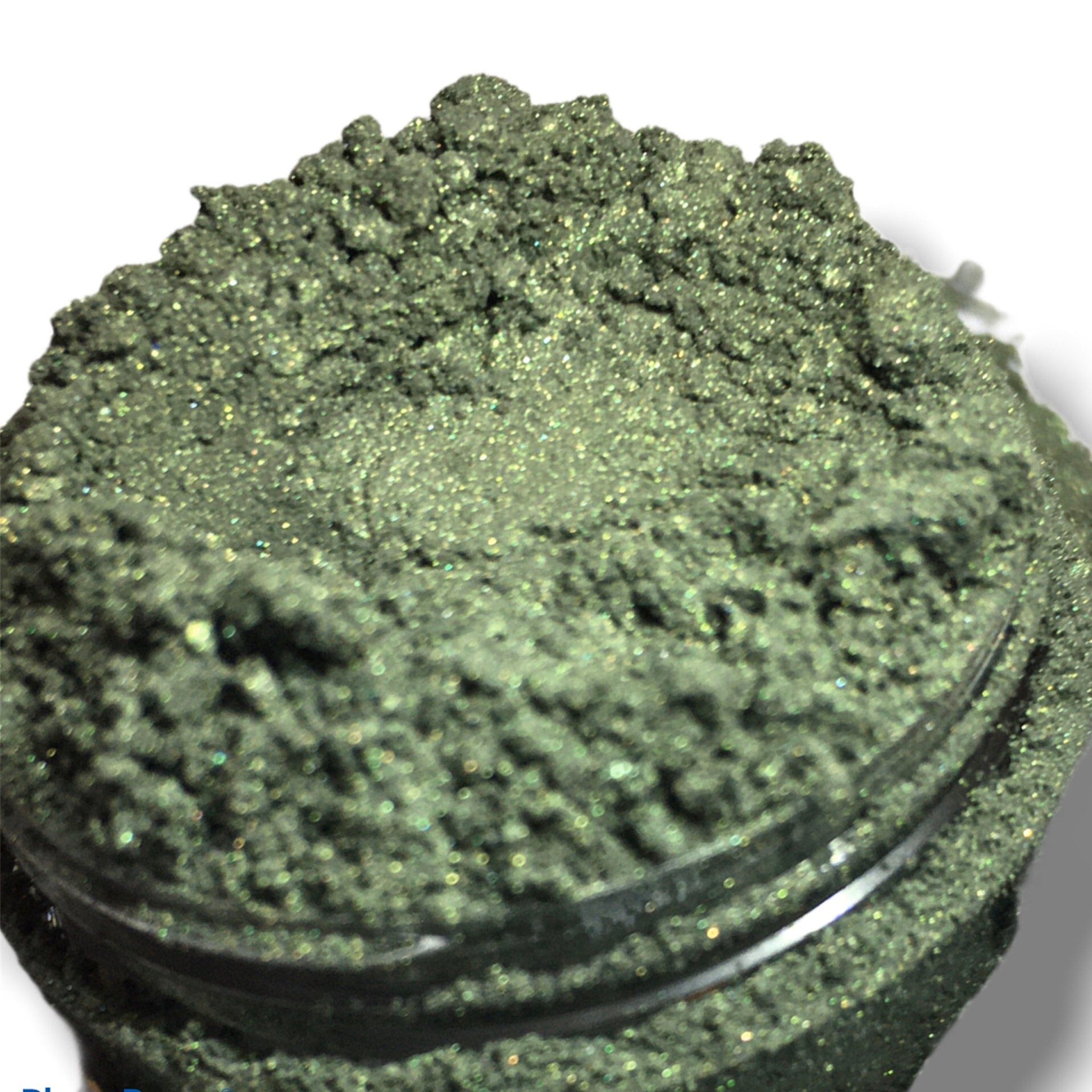 Fresh forest green shimmer eyeshadow in compact with reflective mineral finish and smooth satin texture.