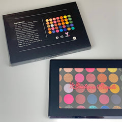 Close-up of shimmering eyeshadow palette showing 35 vibrant glitter and matte shades in circular pans