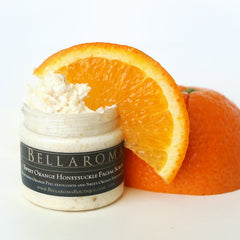 Facial scrub with orange slice, white cream, and glass jar with Bella Roma label