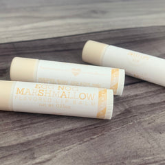 Lip balm tubes with white and beige packaging, Egg Nog Marshmallow flavor, Sweet Lips brand