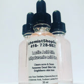 Face serum bottles with black droppers, pink liquid, and AlchemistShopGoods label