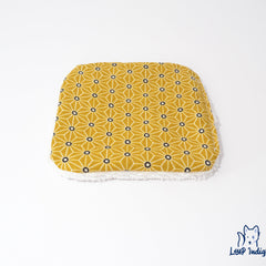 Yellow geometric patterned fabric with white trim, Loup Indigo logo visible