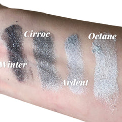 Close-up of silver shimmer eyeshadow with gray undertones in a sifter jar, showcasing glitter particles