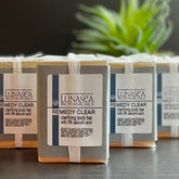 Skin care clarifying body bars wrapped in clear plastic, Remedy Clear label visible