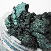 Mineral eyeshadow, emerald green, sparkly, crushed texture in a jar